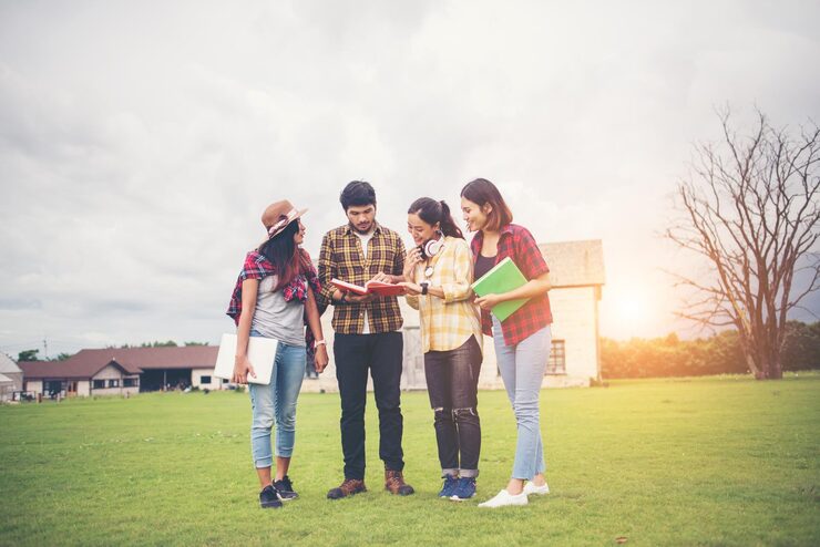 cheerful friends studying while standing field against sky 1048944 28889069